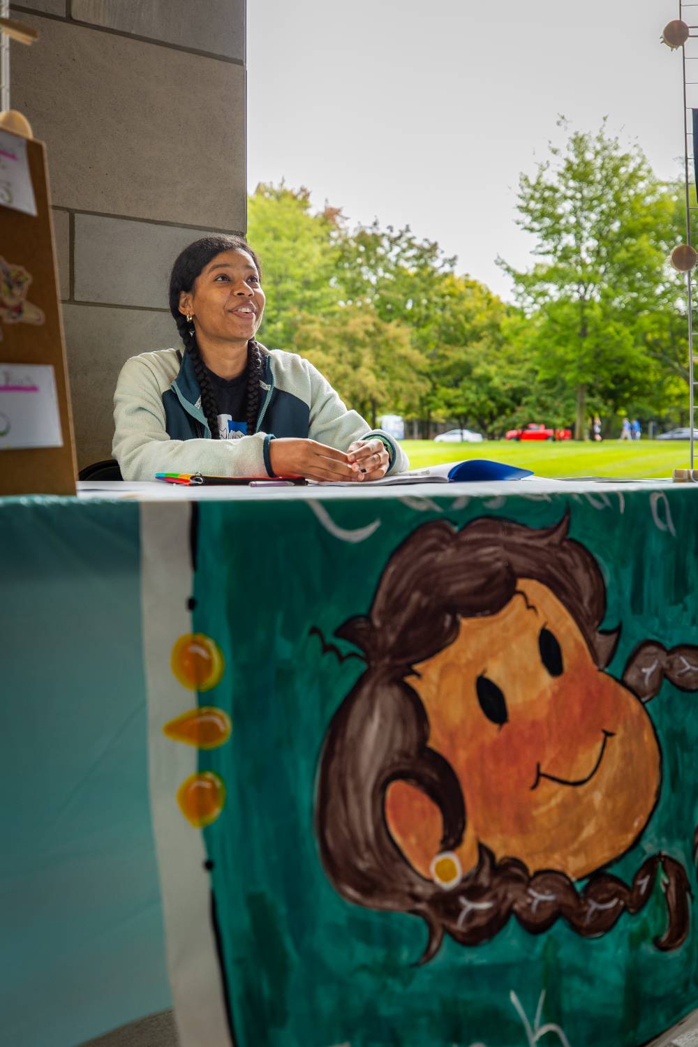 Student working a booth during Student Small Business Market.